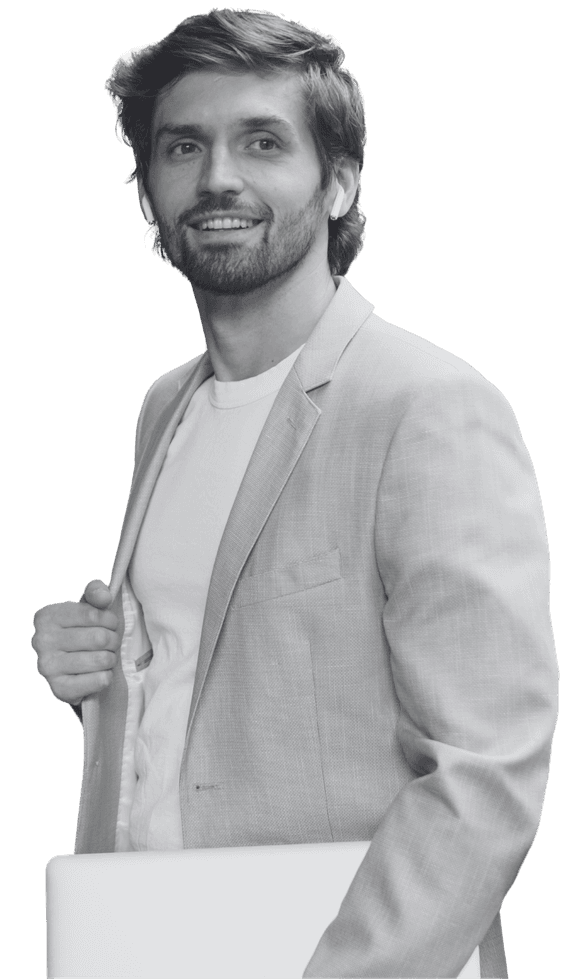 A recruitment consultant standing with a laptop at his side