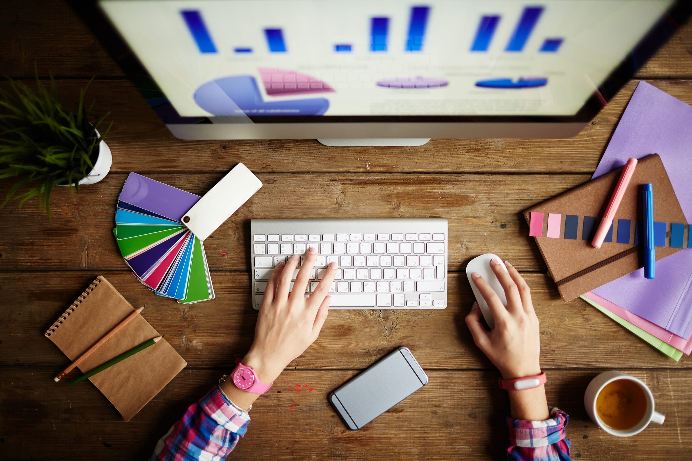 A designer at a desk reviewing colour swatches