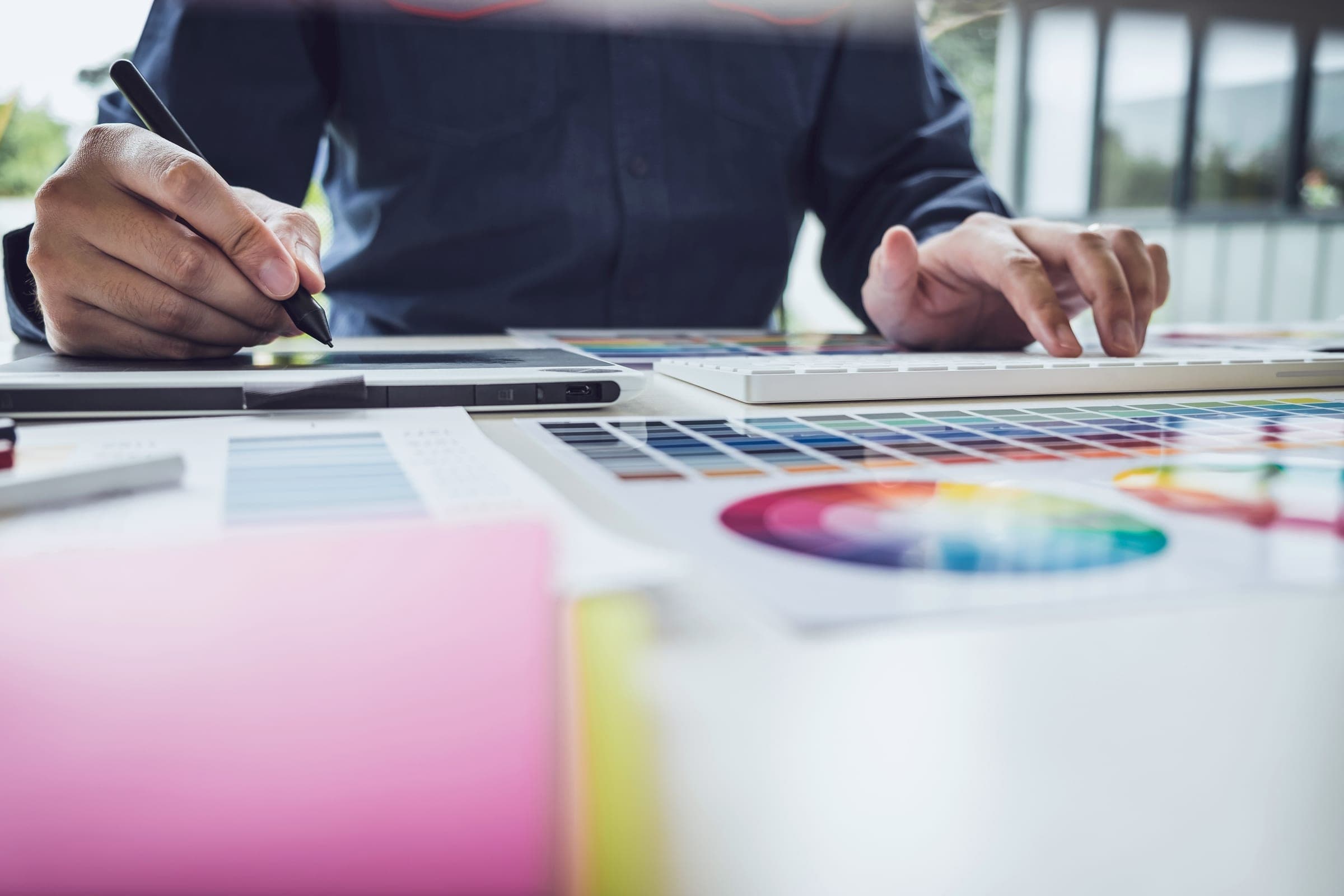 A designer working on a graphics tablet in a modern office