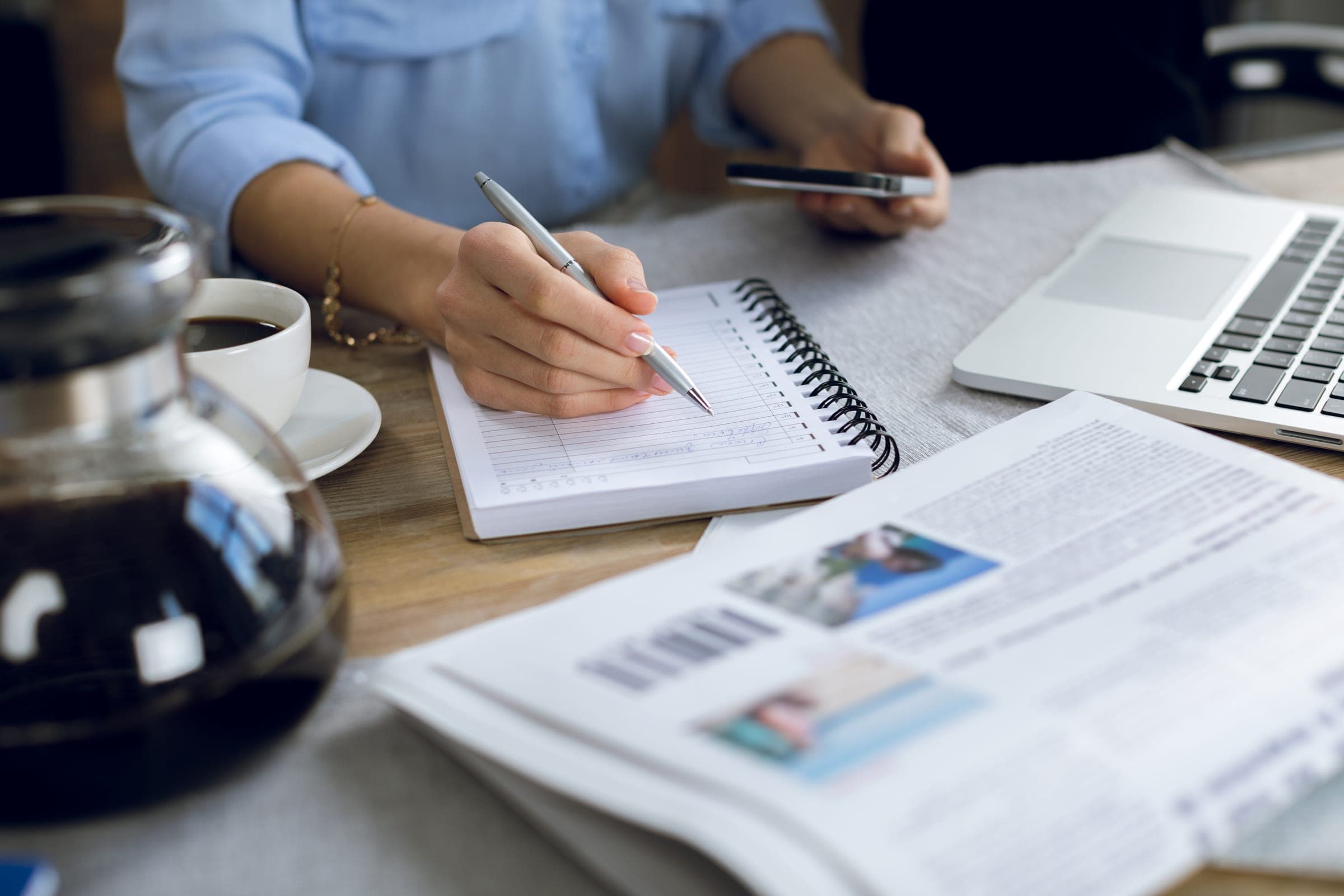 A marketer taking notes while planning content
