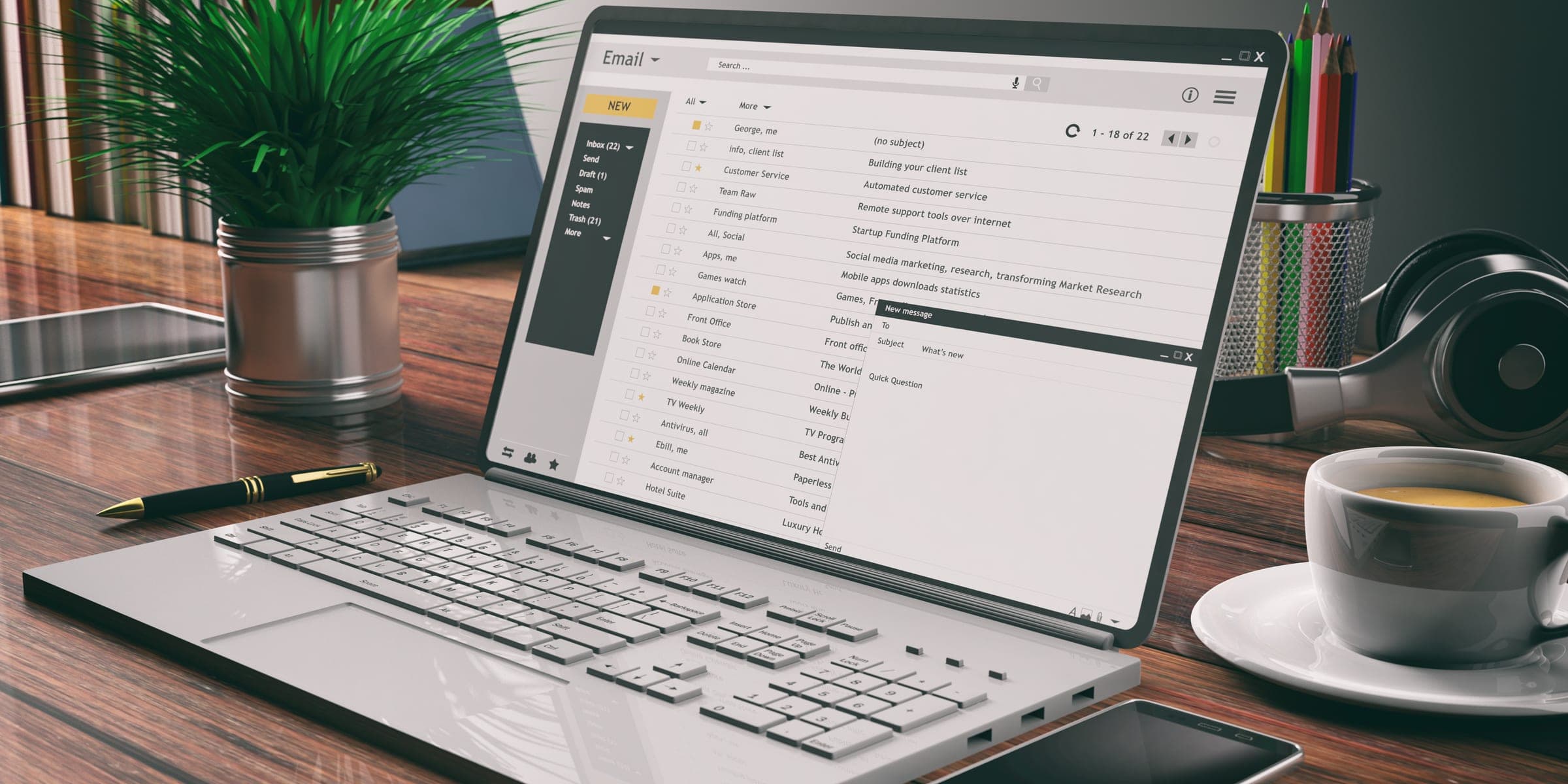 An email inbox open on a laptop beside office supplies