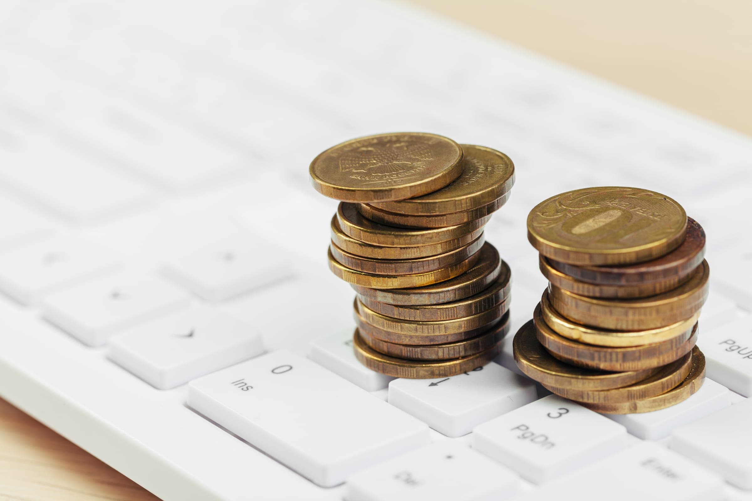Coins stacked on a computer keyboard