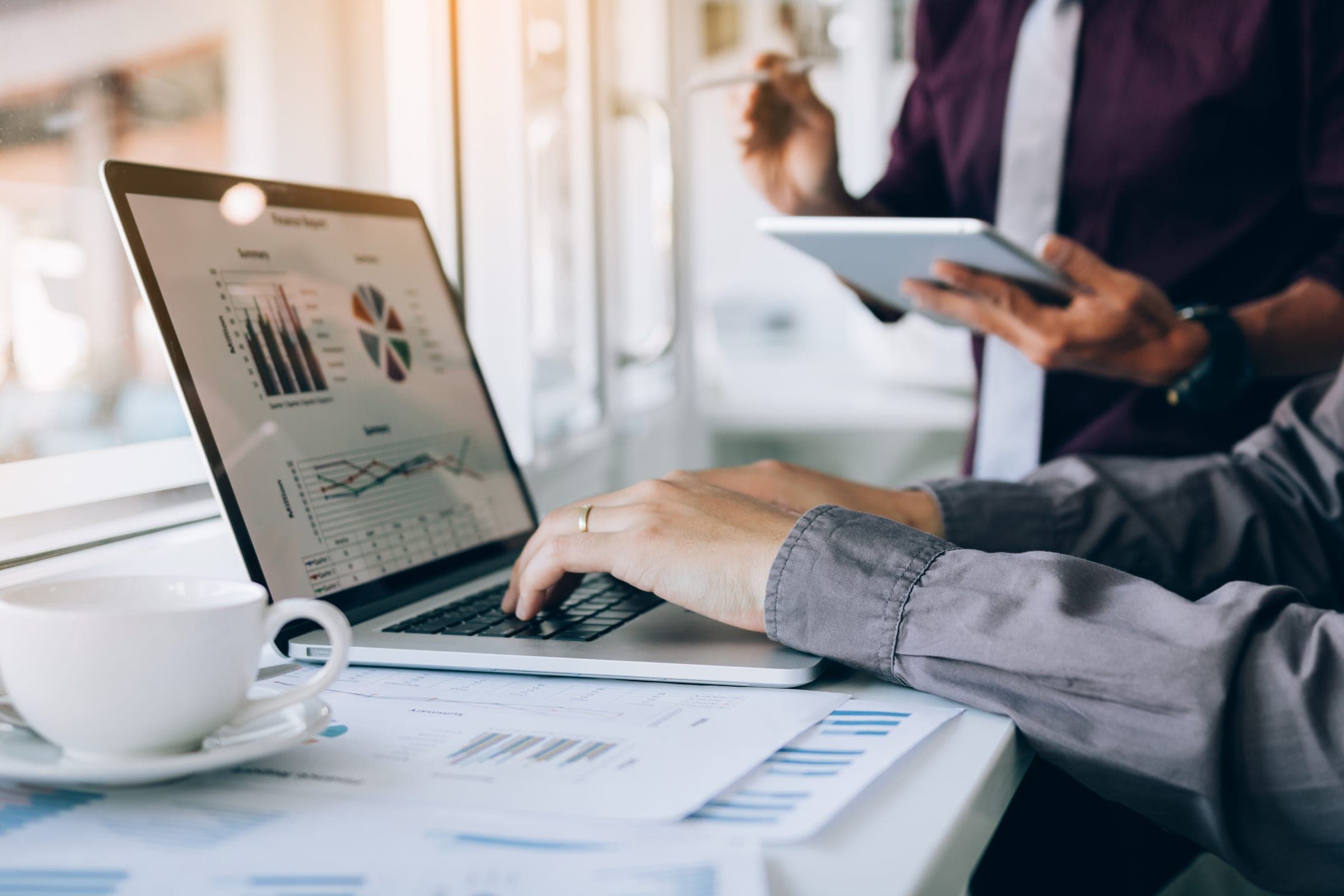A business meeting reviewing reports and analytics