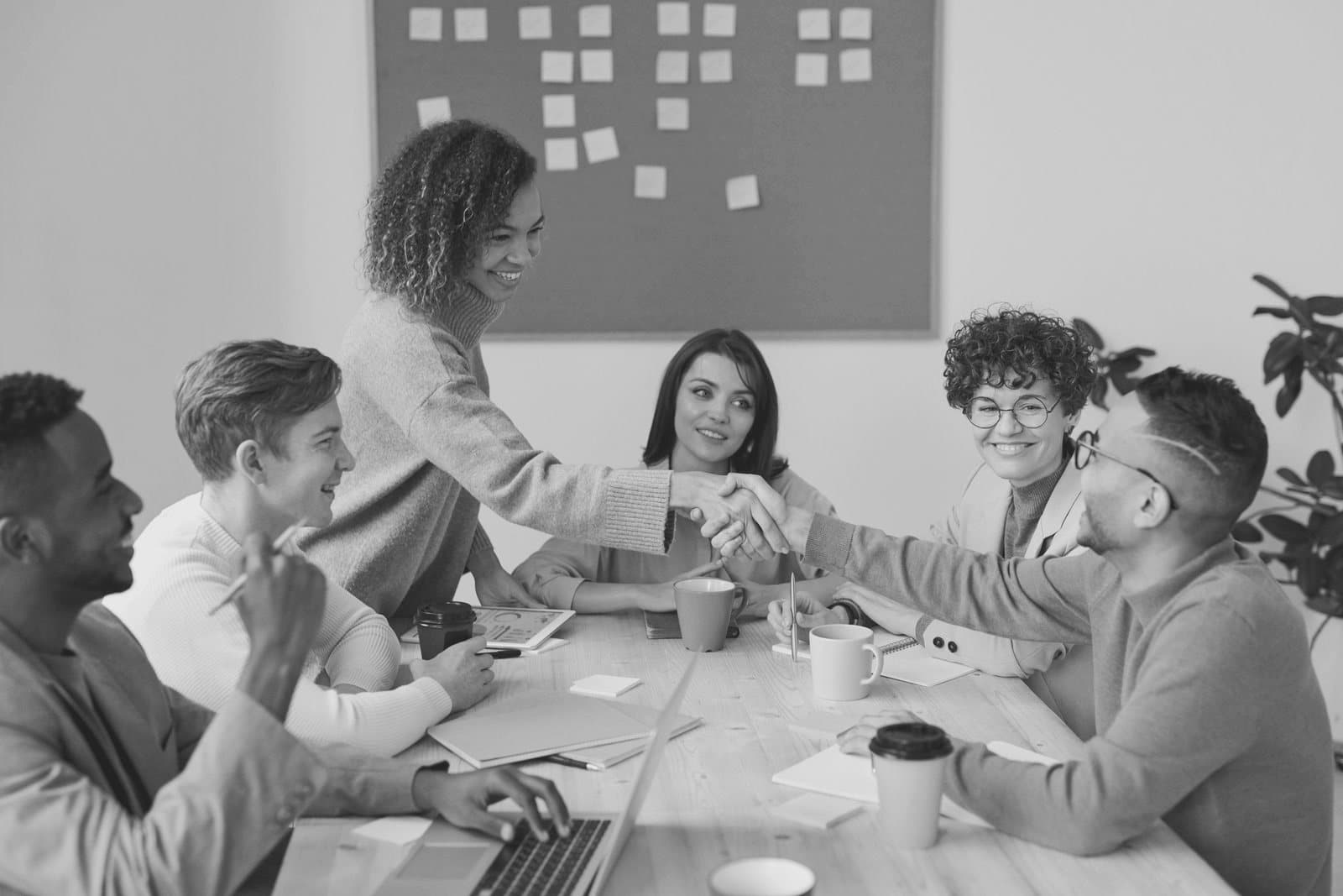 A recruitment marketing team agreeing a content plan around a meeting table