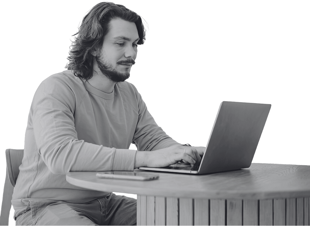 A marketer writing a campaign at his laptop