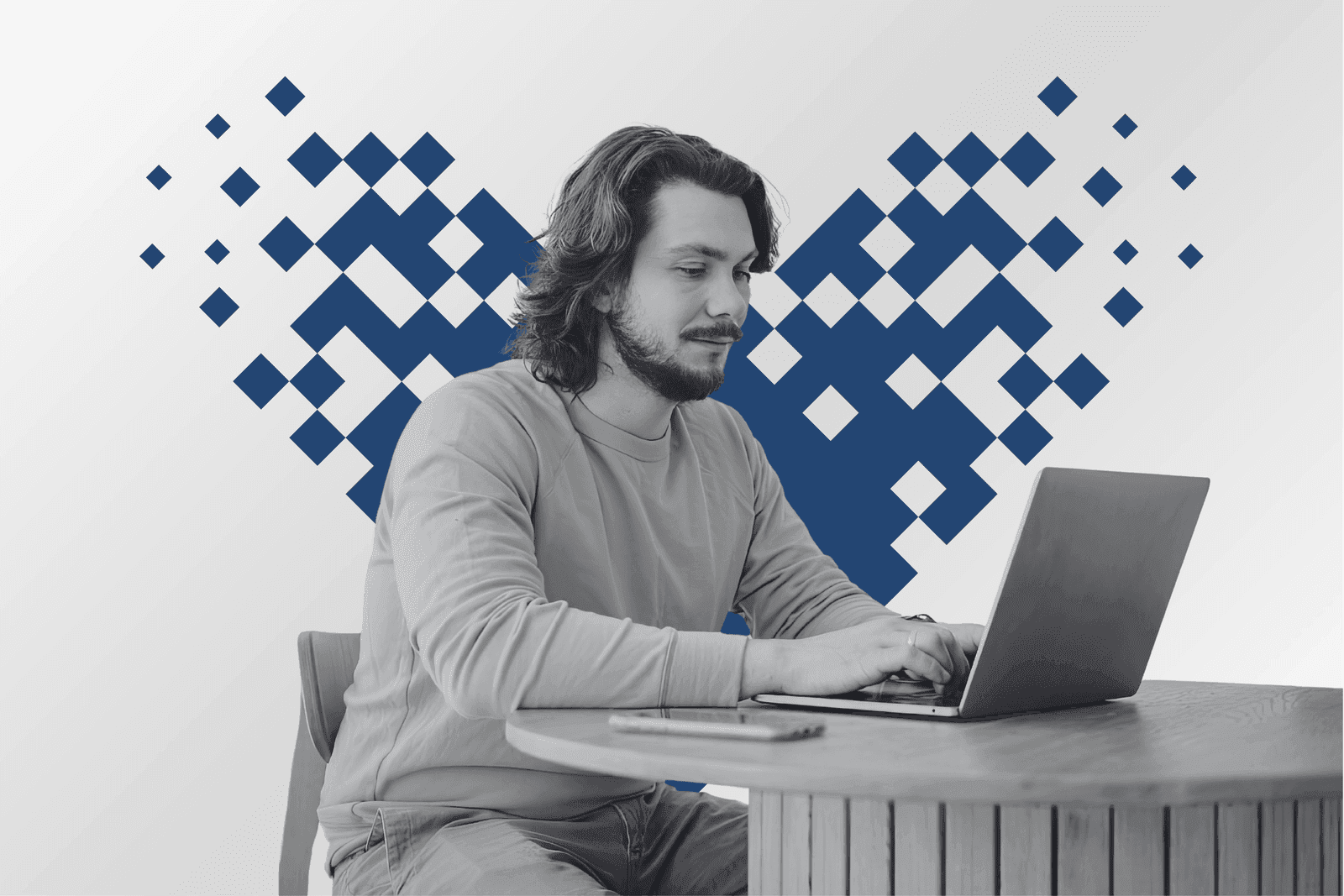 A professional working at a laptop framed by a pixel mosaic heart in azure