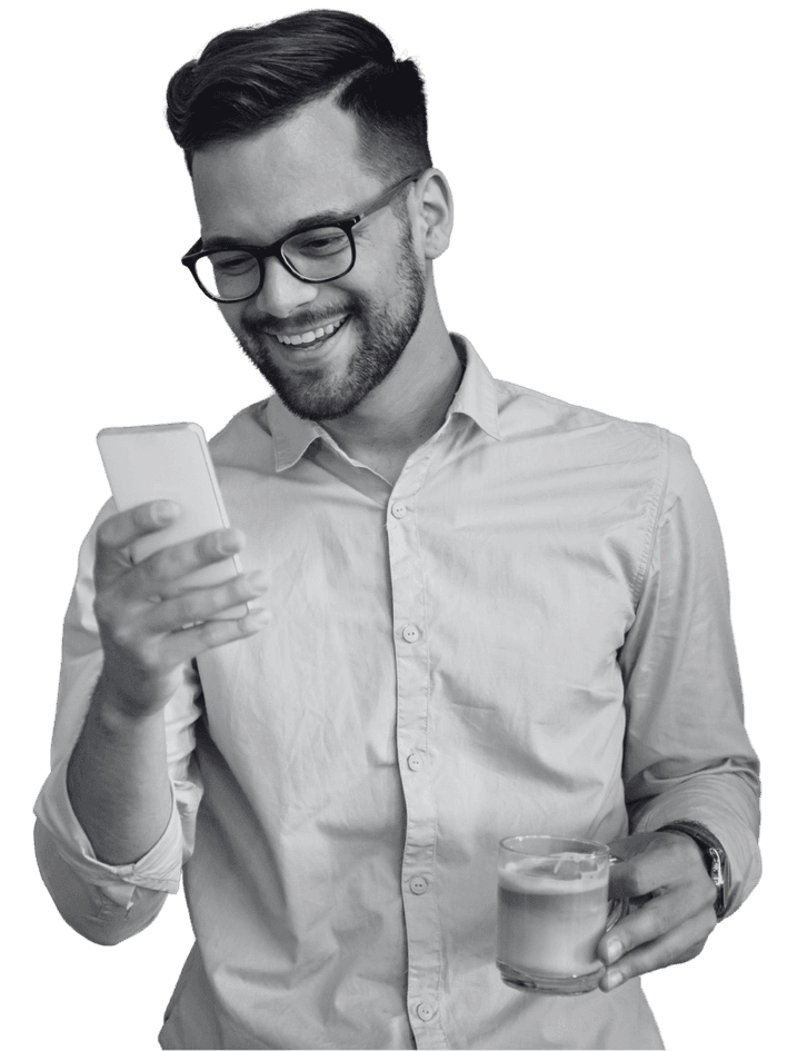 Social media manager reading his phone with a coffee in hand