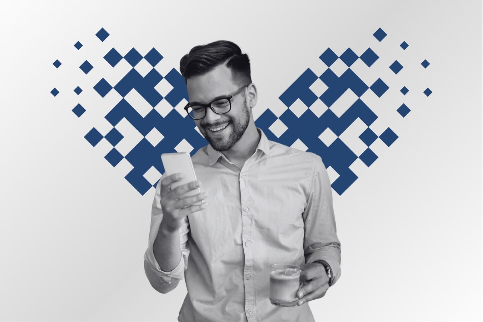 A smiling recruitment professional reading his phone, framed by a pixel mosaic heart in azure
